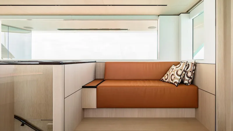 Midnight Saga Yacht Photos Pics Luxurious interior of 2023 Moonen 110 yacht with modern seating and decorative pillows.