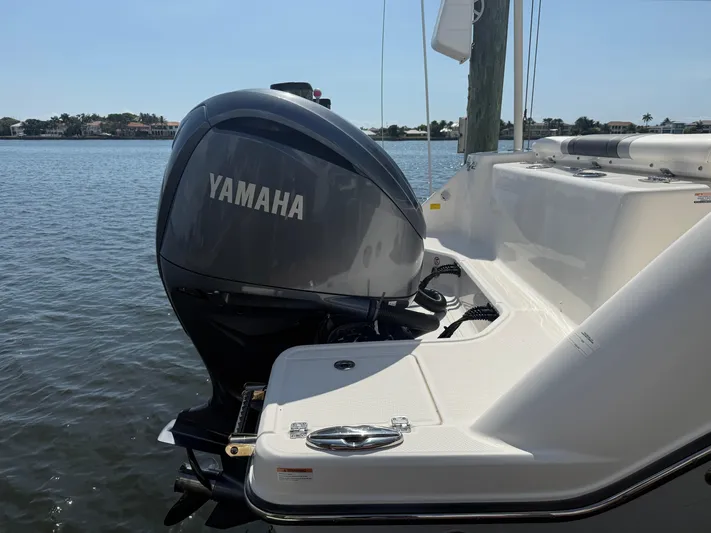 272-203 Brokerage Sebastian Yacht Photos Pics 2023 Robalo R272 Center Console with Yamaha outboard engine on calm water.