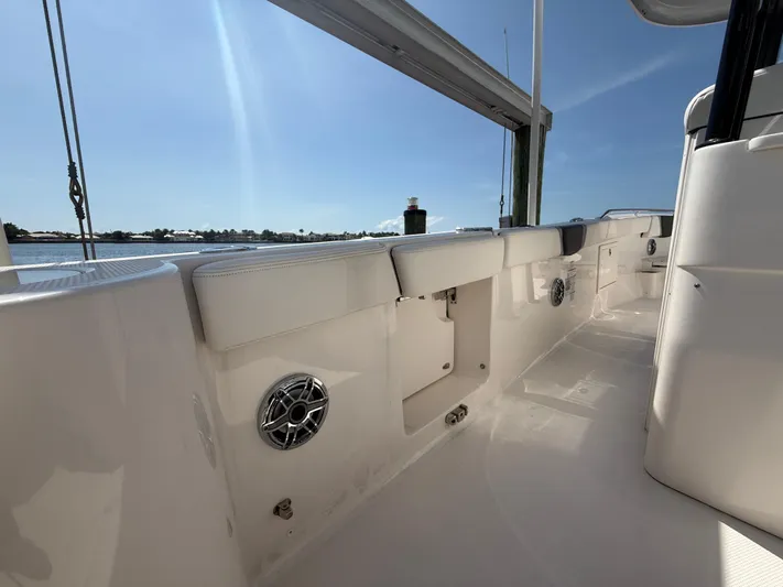 272-203 Brokerage Sebastian Yacht Photos Pics 2023 Robalo R272 Center Console boat interior with sleek white design and speaker system.