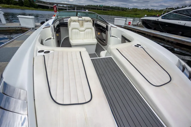 Cobalt 343 Yacht Photos Pics 2005 Cobalt 343 boat with white seating and sleek design docked by the water.