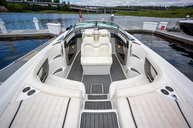 Cobalt 343 Yacht Photos Pics 2005 Cobalt 343 boat interior with white seating, docked by a serene lake.