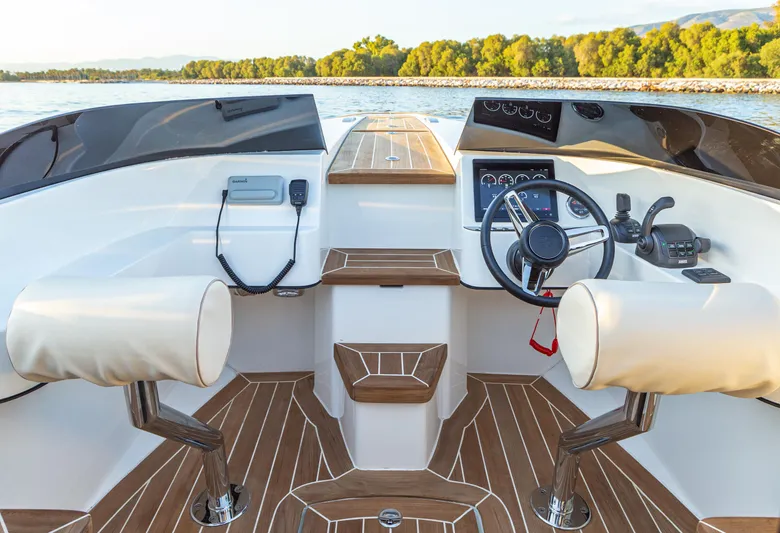  Yacht Photos Pics 2024 Onda 321 LIMO boat interior with modern steering and controls on a sunny day.