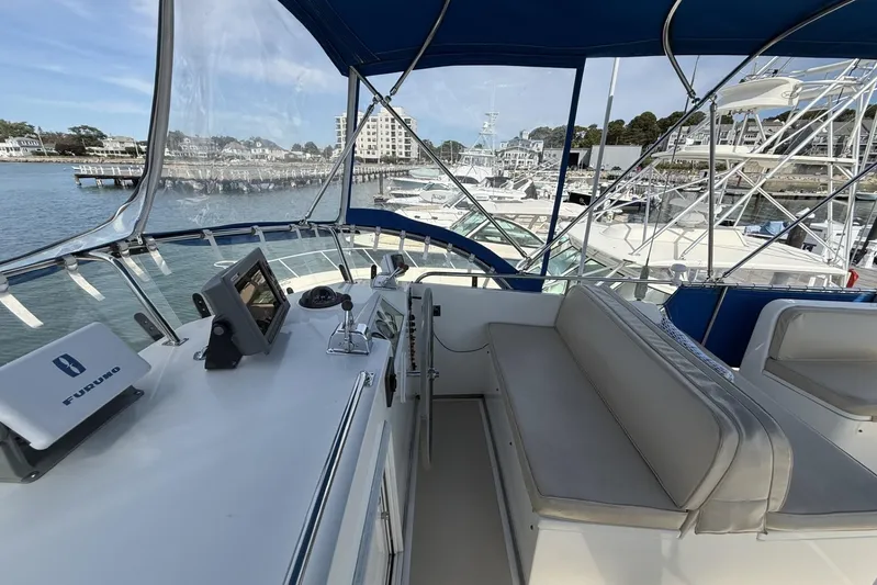  Yacht Photos Pics 1999 Grand Banks 42 Classic yacht helm with navigation equipment and marina view.