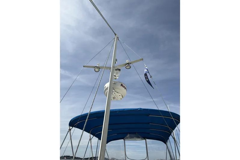  Yacht Photos Pics 1999 Grand Banks 42 Classic yacht with blue canopy and radar equipment against a clear sky.