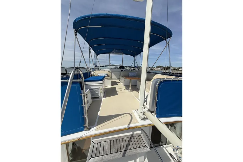  Yacht Photos Pics 1999 Grand Banks 42 Classic yacht deck with blue canopy and seating area.