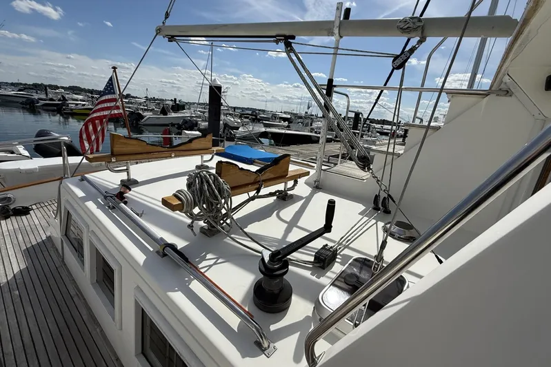  Yacht Photos Pics 1999 Grand Banks 42 Classic yacht deck with American flag, docked at marina.