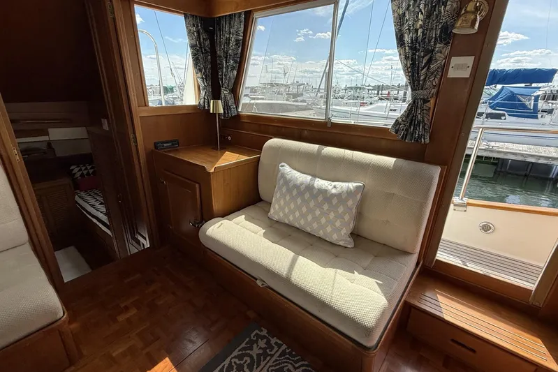 Yacht Photos Pics Interior of 1999 Grand Banks 42 Classic yacht with cozy seating and marina view.