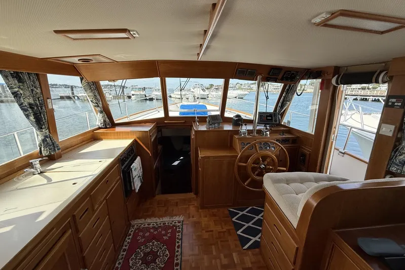  Yacht Photos Pics Interior of 1999 Grand Banks 42 Classic yacht with wooden helm and kitchen area.