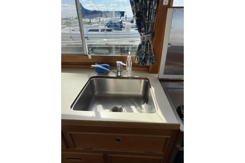  Yacht Photos Pics Stainless steel sink in 1999 Grand Banks 42 Classic yacht kitchen with marina view.