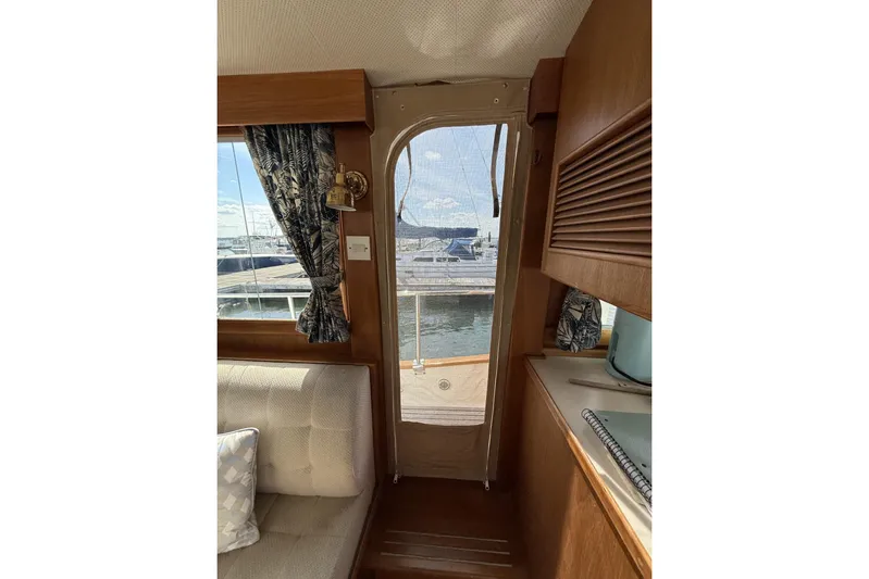  Yacht Photos Pics Interior view of 1999 Grand Banks 42 Classic yacht, featuring cozy seating and nautical decor.