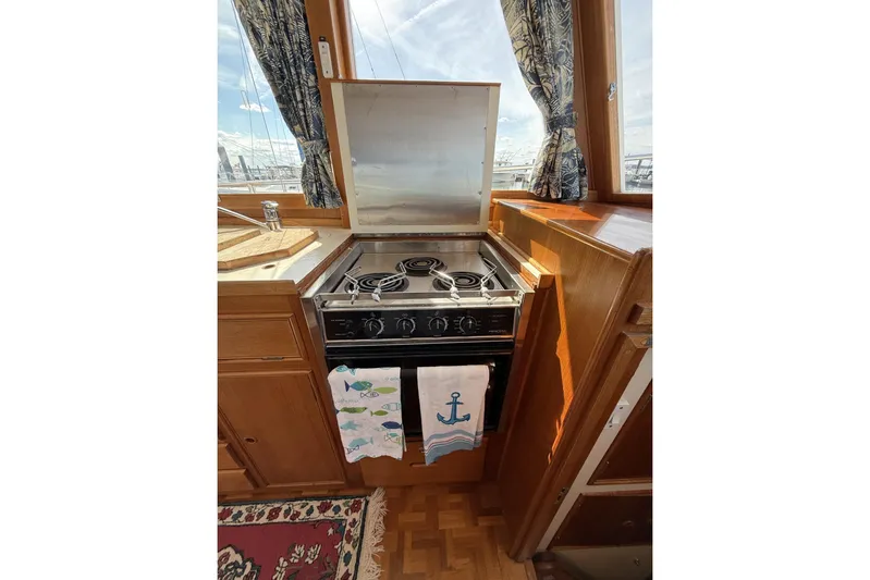  Yacht Photos Pics Galley kitchen in 1999 Grand Banks 42 Classic yacht with stove and nautical decor.