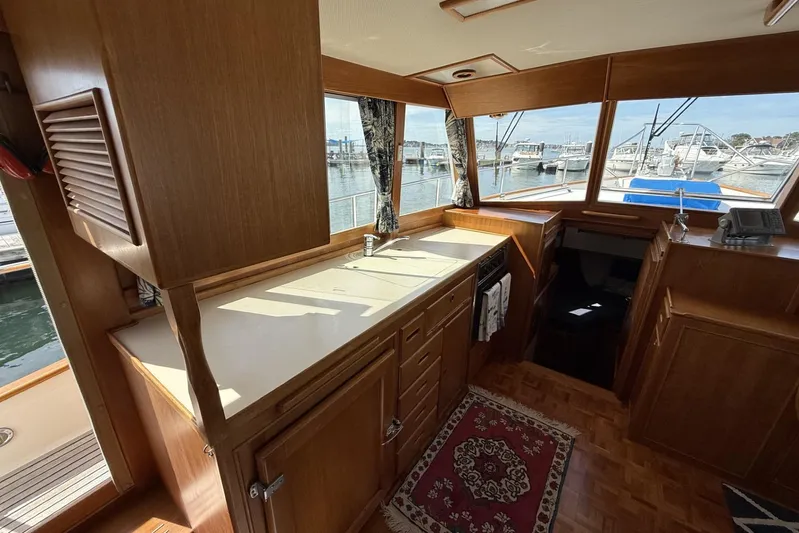  Yacht Photos Pics Interior of 1999 Grand Banks 42 Classic yacht with wooden cabinetry and marina view.