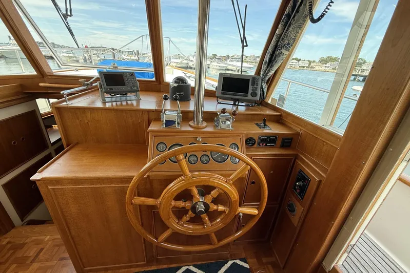  Yacht Photos Pics Helm of 1999 Grand Banks 42 Classic yacht with wooden wheel and navigation instruments.