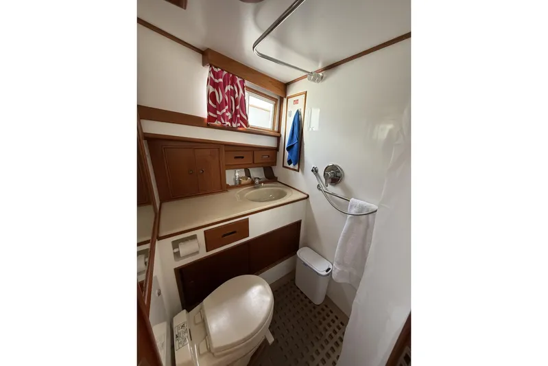 Yacht Photos Pics Bathroom interior of 1999 Grand Banks 42 Classic yacht, featuring sink, toilet, and shower.