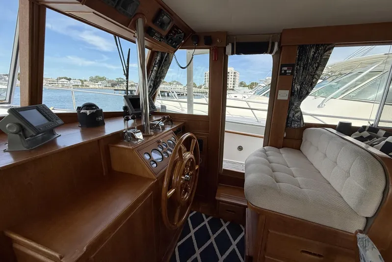  Yacht Photos Pics Interior of 1999 Grand Banks 42 Classic yacht with wooden helm and plush seating.