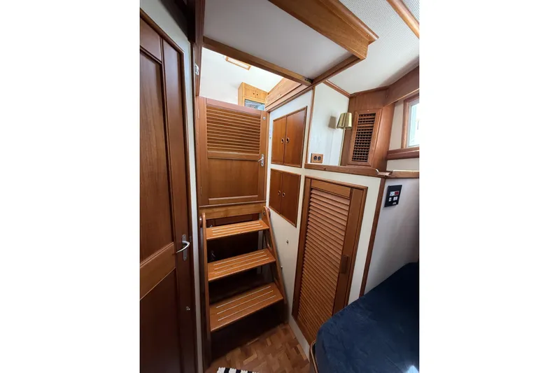  Yacht Photos Pics Interior of 1999 Grand Banks 42 Classic yacht with wooden stairs and cabinetry.