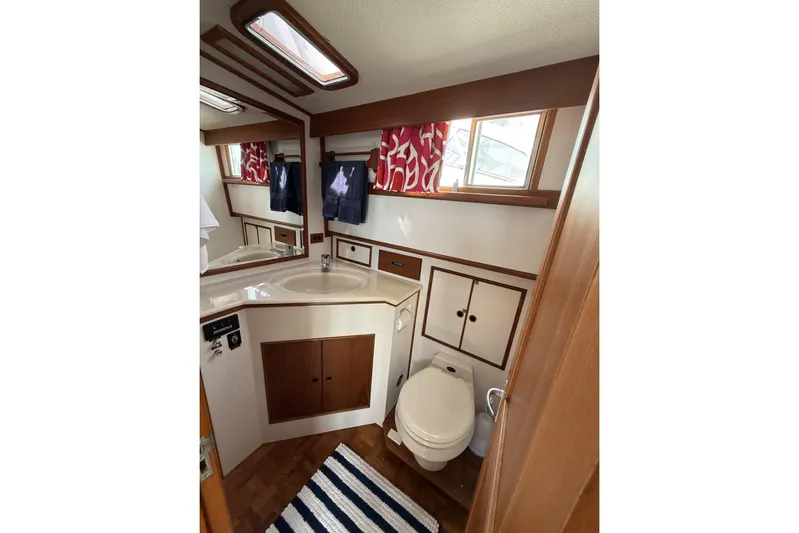  Yacht Photos Pics Bathroom interior of 1999 Grand Banks 42 Classic yacht with wood accents and nautical decor.