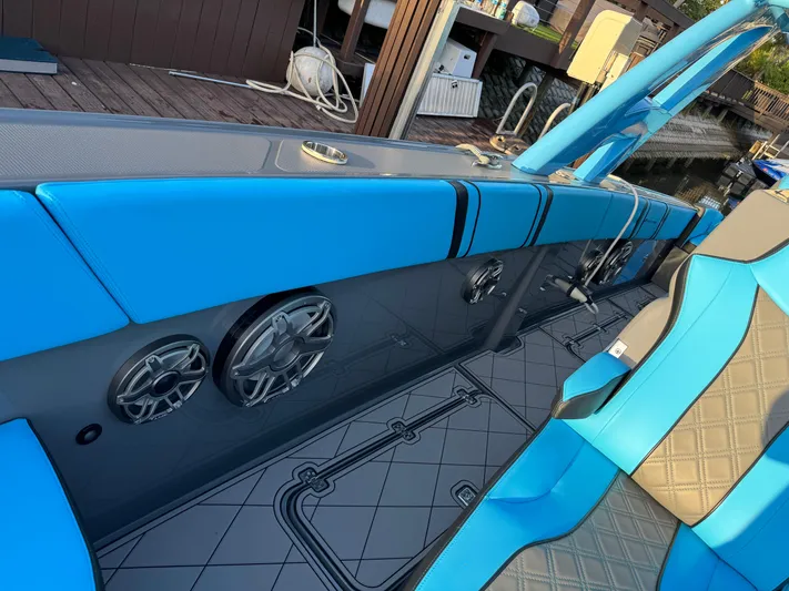 Do Better Yacht Photos Pics 2021 Midnight Express 37 Open boat interior with blue seating and built-in speakers.