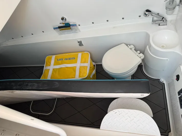 Do Better Yacht Photos Pics Interior of 2021 Midnight Express 37 Open boat with toilet, sink, and life jacket.