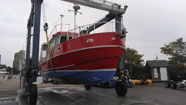 Moondance Yacht Photos Pics Red 2007 Custom Rockport Steel Trawler MY on a boat lift for maintenance.