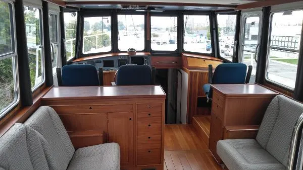 Moondance Yacht Photos Pics Interior of 2007 Custom Rockport Steel Trawler MY with wooden cabinetry and seating.