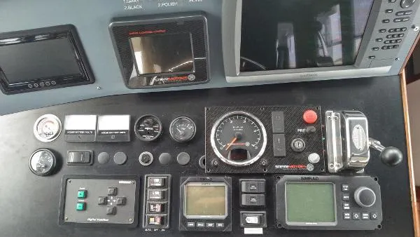 Moondance Yacht Photos Pics Control panel of a 2007 Custom Rockport Steel Trawler MY with various gauges and displays.
