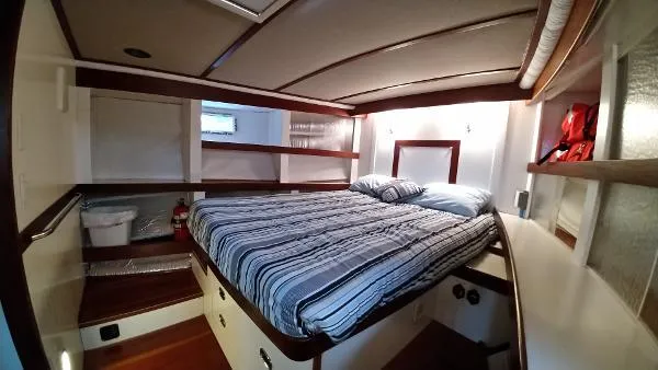 Moondance Yacht Photos Pics Cozy bedroom in 2007 Custom Rockport Steel Trawler MY with striped bedding.