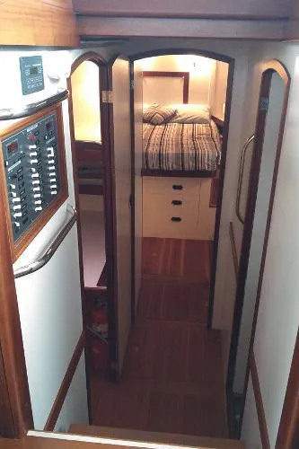 Moondance Yacht Photos Pics Interior cabin of 2007 Custom Rockport Steel Trawler MY with bed and control panel.