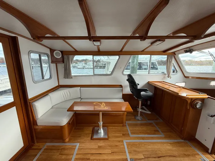 Screamer Yacht Photos Pics Interior of 1998 Wilbur 38 Downeast boat with seating and helm, featuring wood accents.