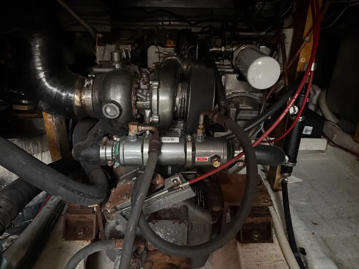 Screamer Yacht Photos Pics Engine compartment of a 1998 Wilbur 38 Downeast boat, showcasing mechanical components.