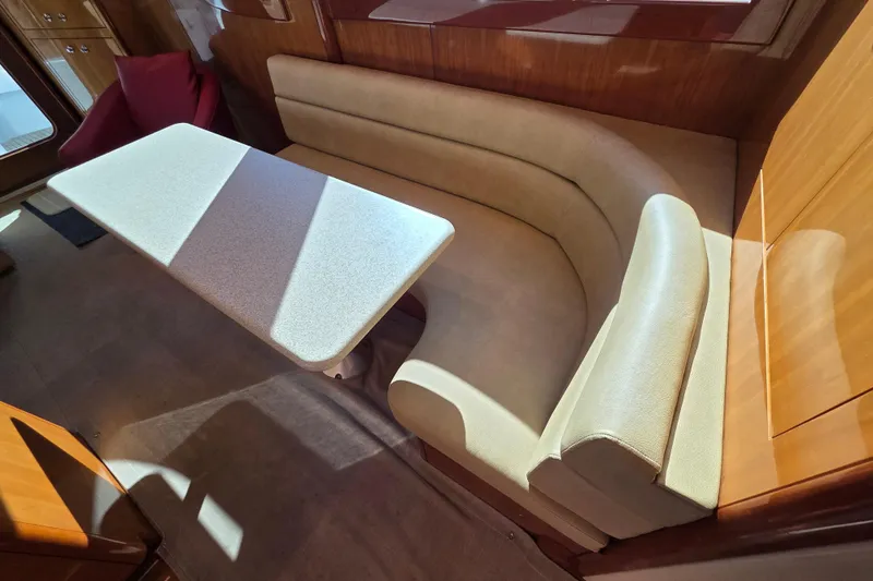  Yacht Photos Pics Interior of 2006 Hatteras 50 Convertible yacht with curved seating and table.