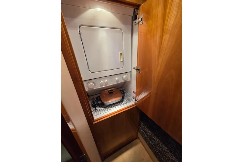  Yacht Photos Pics Laundry area inside 2006 Hatteras 50 Convertible yacht with wooden cabinetry.