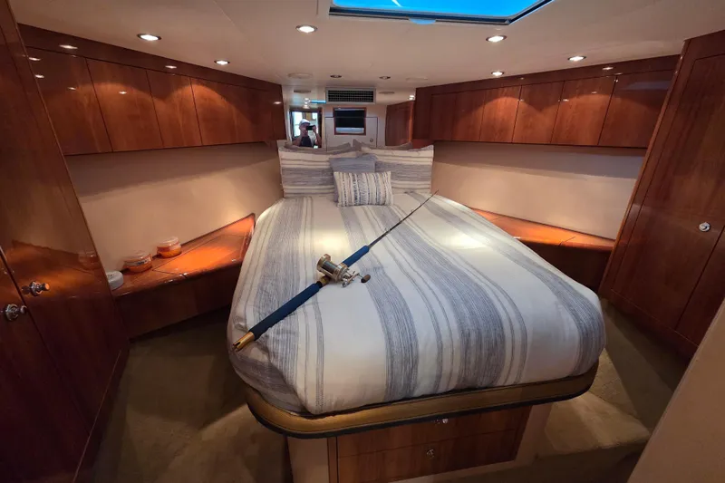  Yacht Photos Pics Luxurious cabin interior of 2006 Hatteras 50 Convertible yacht with striped bedding.
