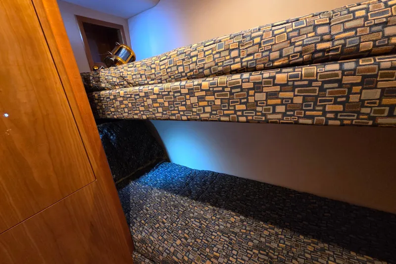  Yacht Photos Pics Bunk beds in 2006 Hatteras 50 Convertible yacht cabin with patterned upholstery.