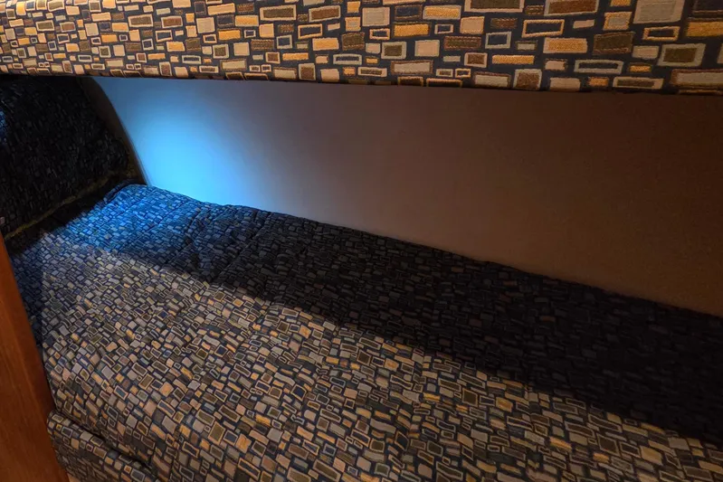  Yacht Photos Pics Bunk bed with patterned upholstery in 2006 Hatteras 50 Convertible yacht interior.