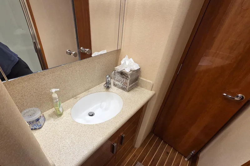  Yacht Photos Pics Bathroom vanity in 2006 Hatteras 50 Convertible yacht with sink and wooden cabinetry.