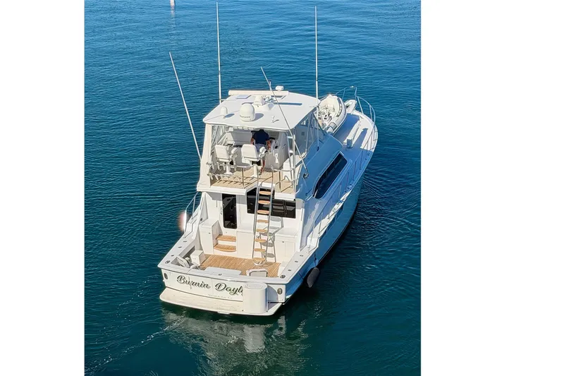  Yacht Photos Pics 2005 Hatteras 50 Convertible yacht on calm blue water.