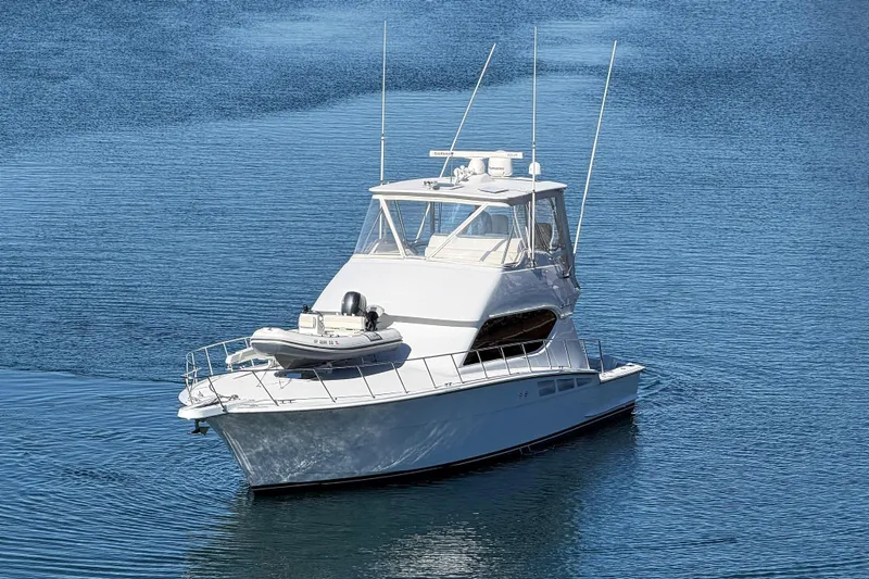  Yacht Photos Pics 2005 Hatteras 50 Convertible yacht on calm blue water.