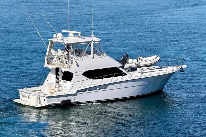  Yacht Photos Pics 2005 Hatteras 50 Convertible yacht cruising on calm blue waters.