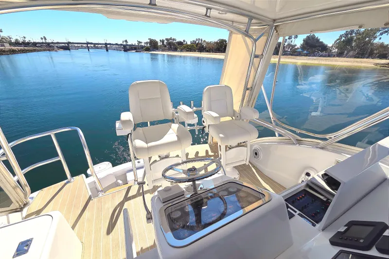  Yacht Photos Pics 2006 Hatteras 50 Convertible yacht helm with dual captain chairs and scenic water view.