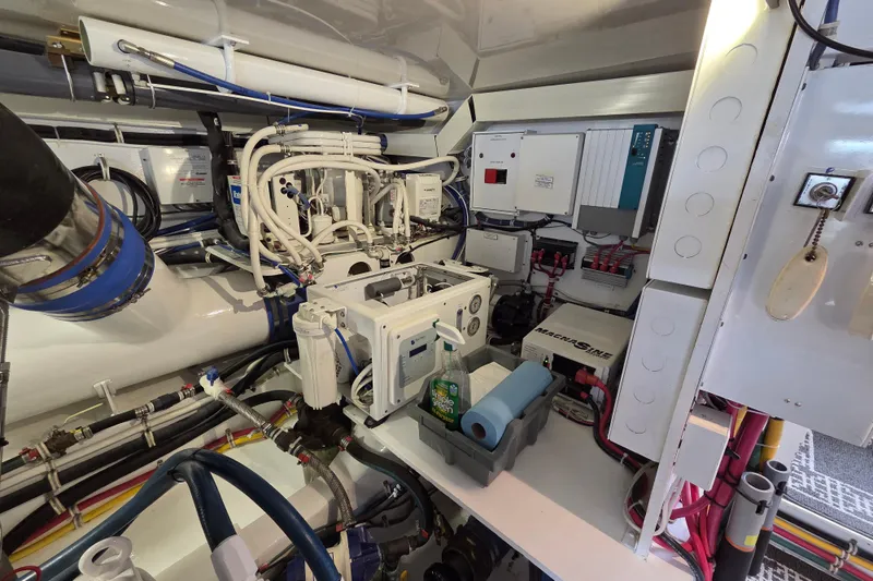  Yacht Photos Pics Engine room of 2006 Hatteras 50 Convertible yacht, showcasing complex machinery and wiring.