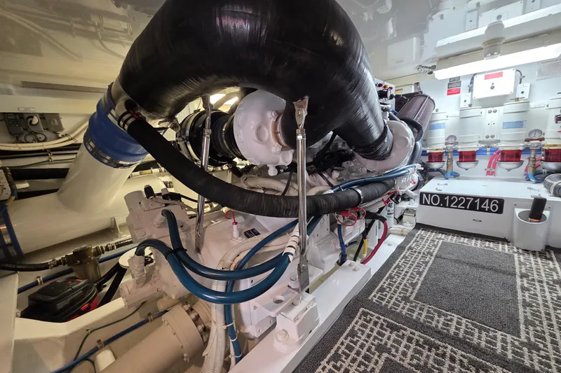 Yacht Photos Pics Engine room of 2006 Hatteras 50 Convertible yacht, showcasing complex machinery and piping.