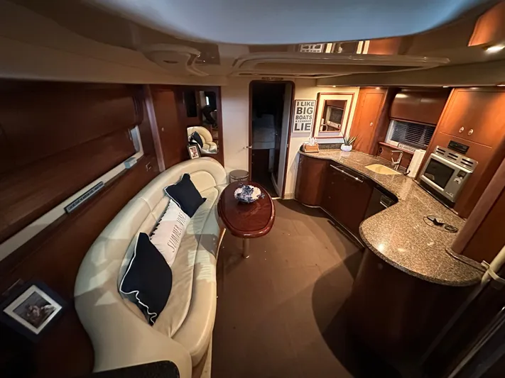  Yacht Photos Pics Luxurious interior of 2007 Sea Ray 44 Sundancer yacht with elegant seating and modern kitchen.