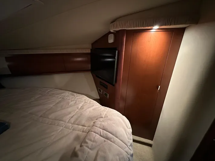  Yacht Photos Pics Interior cabin of 2007 Sea Ray 44 Sundancer with wood paneling and cozy lighting.