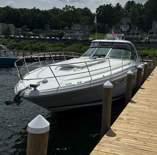  Yacht Photos Pics 2007 Sea Ray 44 Sundancer yacht docked at a wooden pier, surrounded by water and greenery.