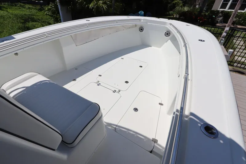  Yacht Photos Pics 2013 Yellowfin 32 Offshore boat interior with white seating and storage compartments.