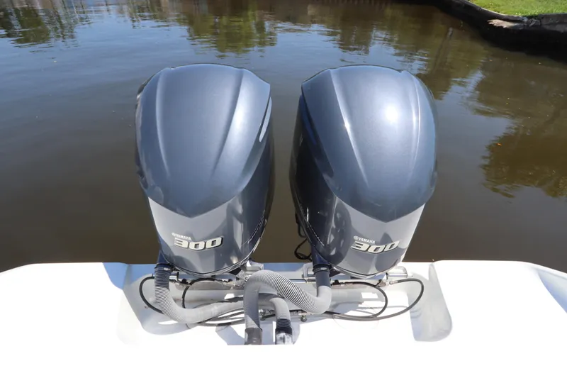  Yacht Photos Pics Twin Yamaha 300 engines on a 2013 Yellowfin 32 Offshore boat, docked on calm water.