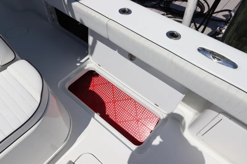  Yacht Photos Pics 2013 Yellowfin 32 Offshore boat with open storage compartment and red mat.