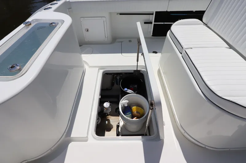  Yacht Photos Pics 2013 Yellowfin 32 Offshore boat interior with storage compartment and seating.