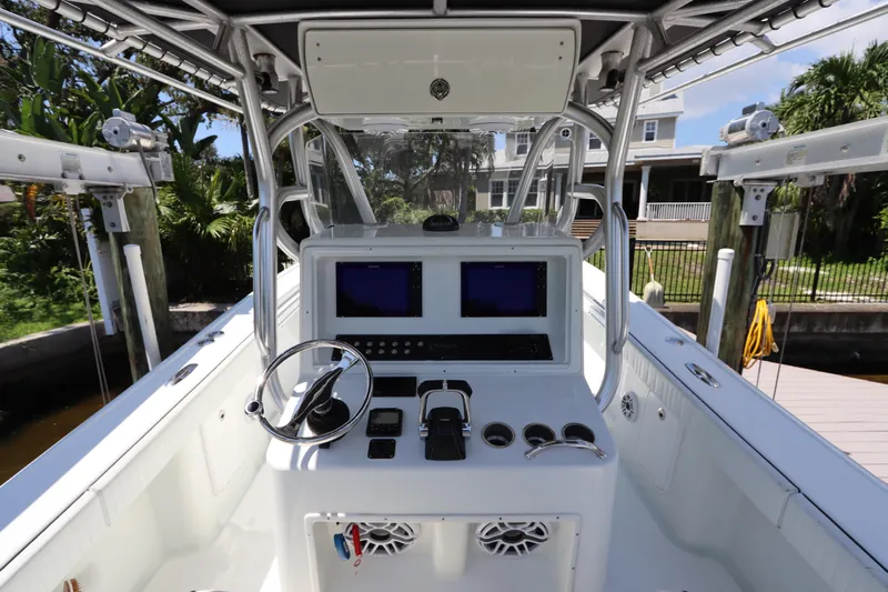  Yacht Photos Pics 2013 Yellowfin 32 Offshore boat cockpit with dual screens and steering wheel.